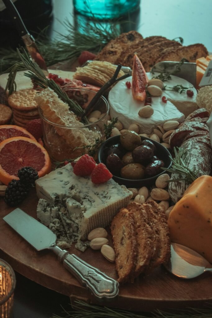 Tabla de quesos con frutos secos, aceitunas, pan y pomelo